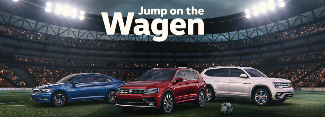 Jump on the Wagen Title and Three VW Vehicles in a Soccer Stadium