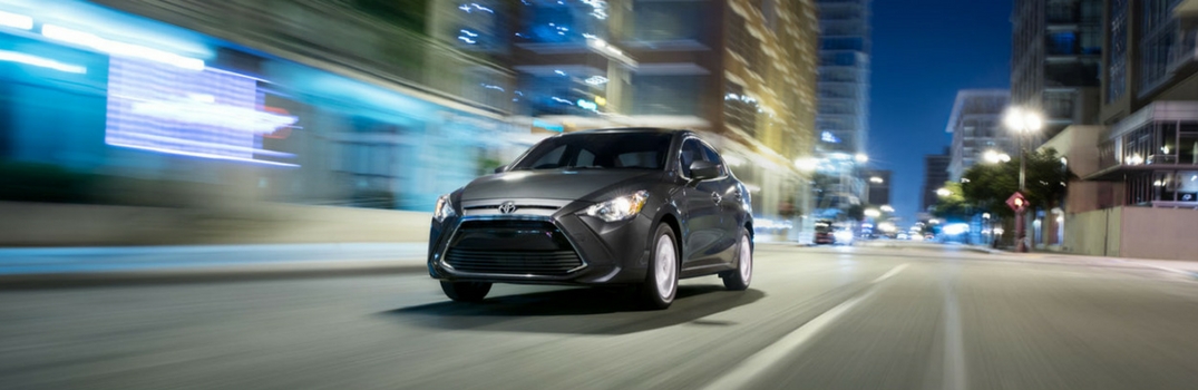 2018 Toyota Yaris iA driving down the road.