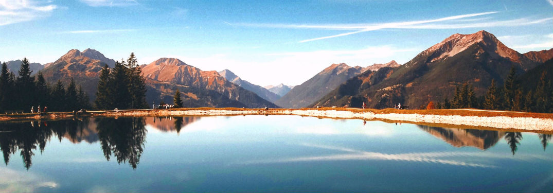 Sun rising over a mountain lake