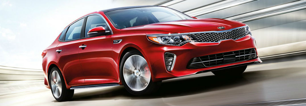 Passenger side exterior view of a red 2018 Kia Optima