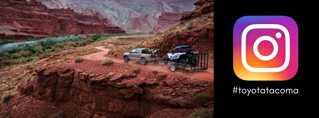 picture-of-2018-Toyota-Tacoma-towing-trailer-down-off-road-decline-next-to-Instagram-logo-and-toyotatacoma-hashtag