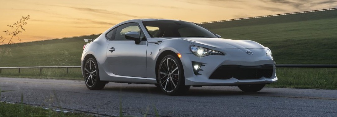 White 2020 Toyota 86 parked next to a grassy field