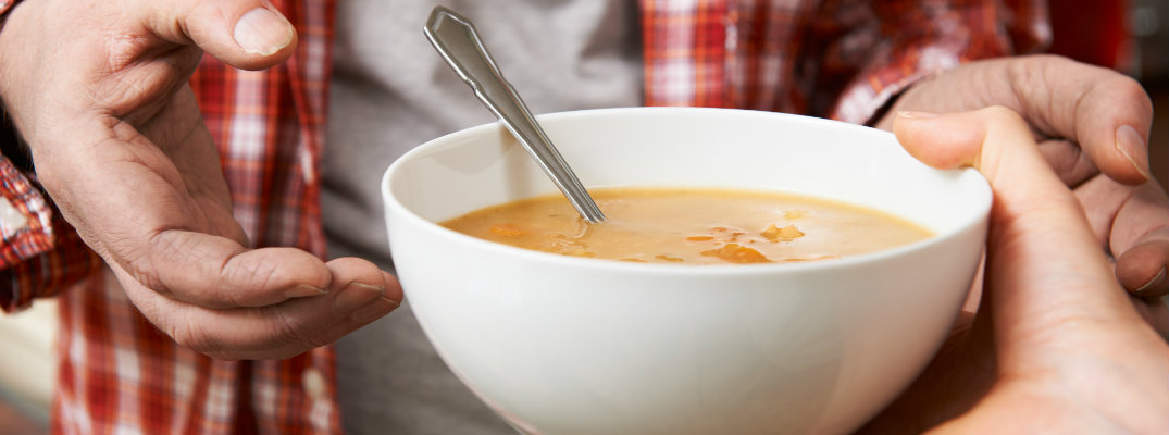 soup being handed to a man