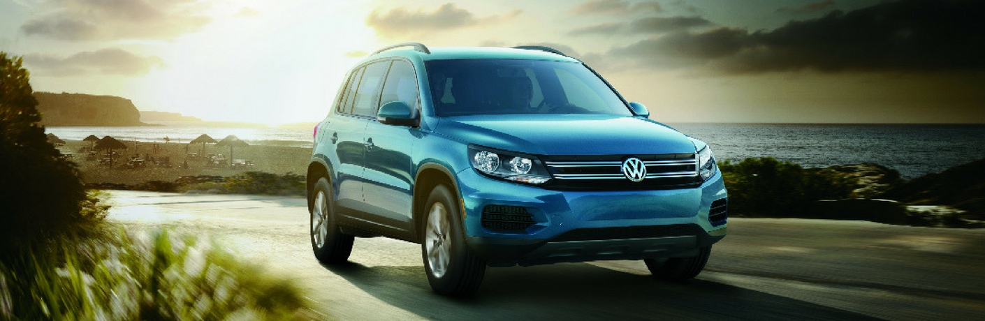 2017 VW Tiguan Limited driving with the sun rising behind it