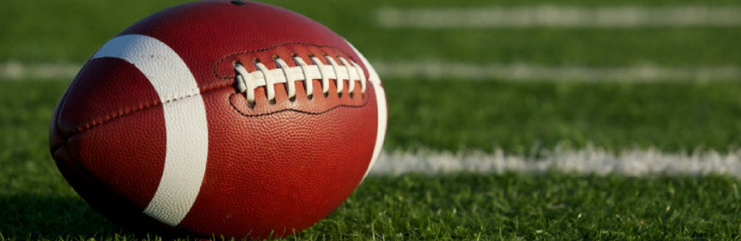 Brown football on football field