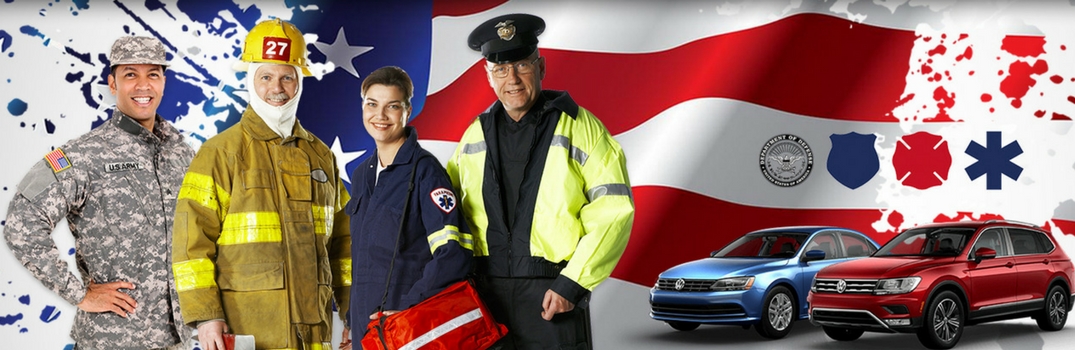 Military and first responder personnel in front of flag with vw vehicles