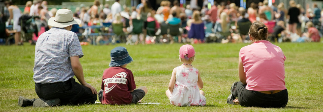Family in bucket hats staring at crowd