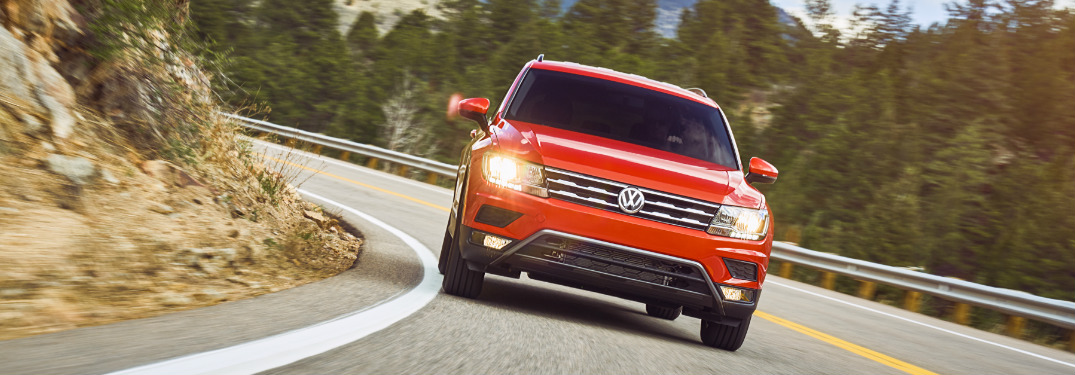 Orange 2019 VW Tiguan Driving on a Curvy Mountain Road