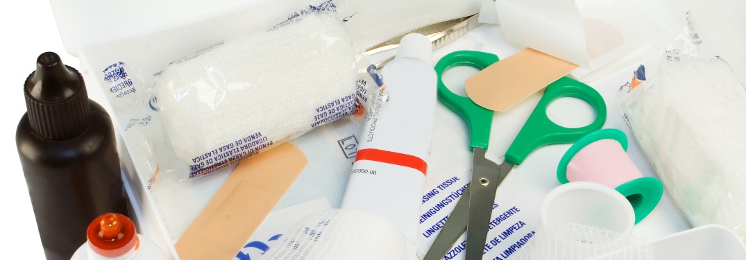 stock photo of first aid kit scissors gauze and ointment