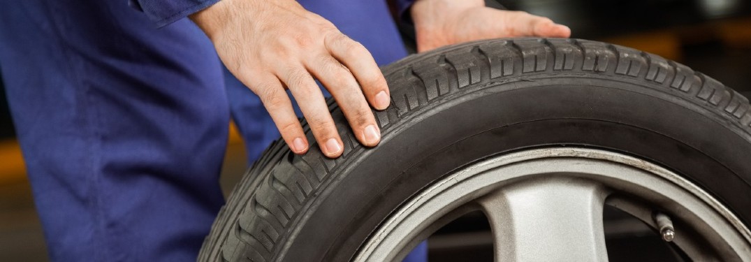 stock photo of person rolling tire by hand close up