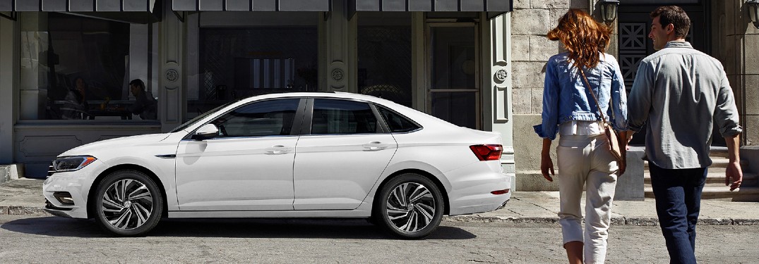 2020 Volkswagen Jetta white exterior shot with couple walking toward it