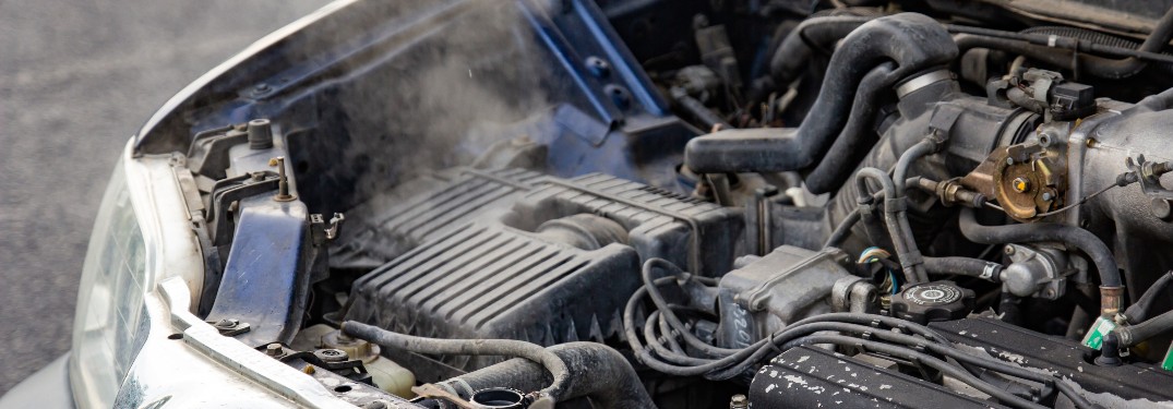 steaming car engine overheated hood up