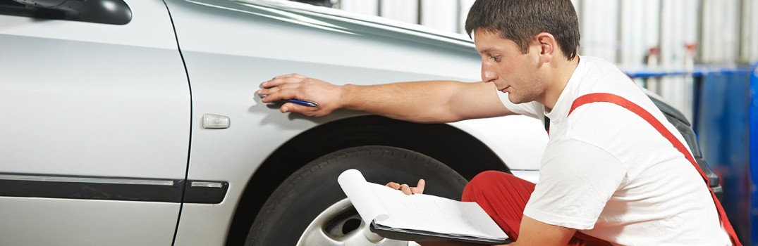 man checking out a car