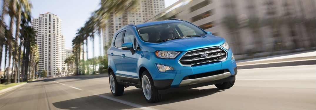 blue 2018 Ford EcoSport driving down a city street