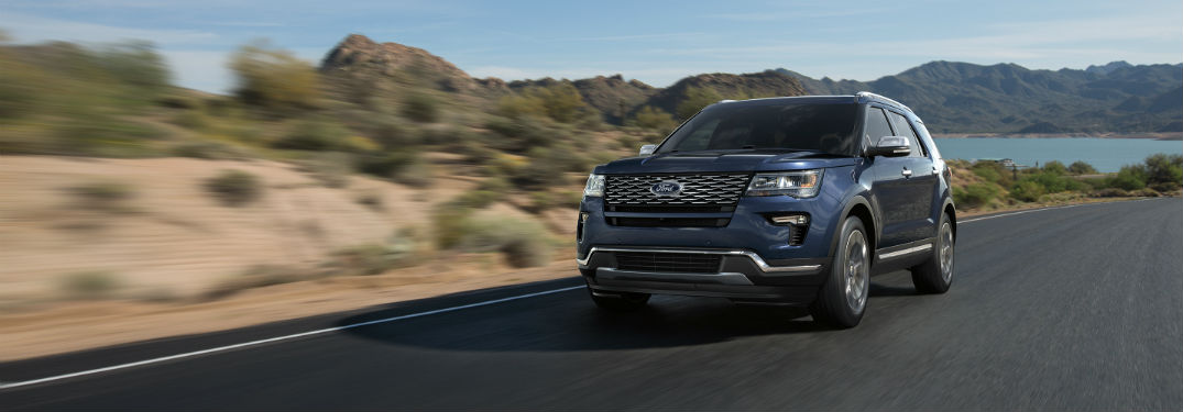 blue 2018 Ford Explorer driving down a desert road