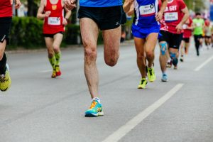 photo showing the legs of runners in a 5K