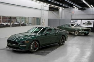 green 2019 Ford Mustang Bullitt parked with a green 1968 Ford Mustang GT Fastback parked in the background