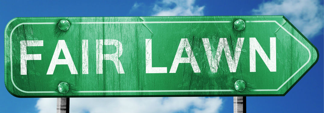 green sign pointing to the fair lawn