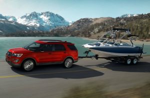red 2017 Ford Explorer towing boat