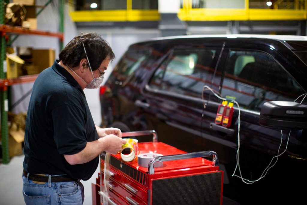 man sanitizing a car