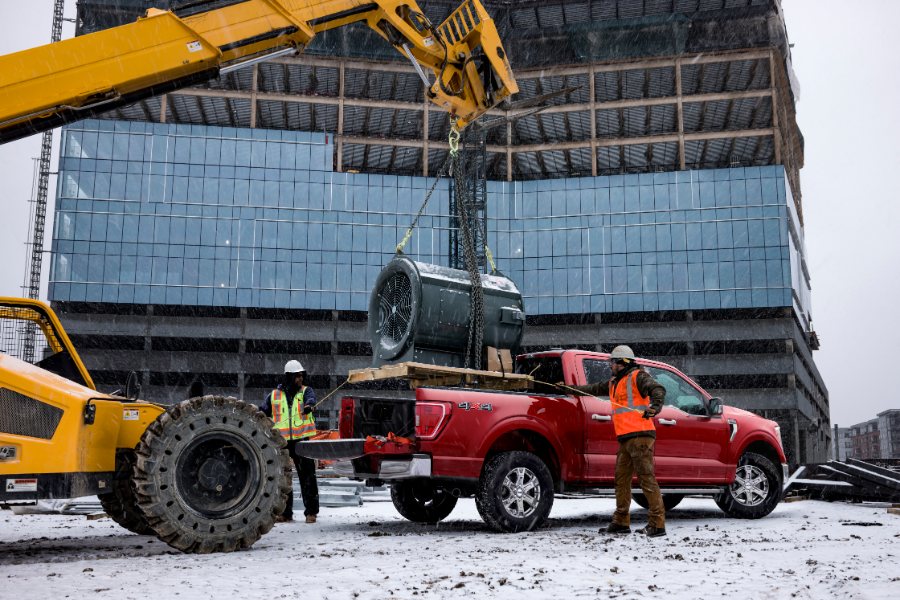 red 2021 Ford F-150 at a construction site