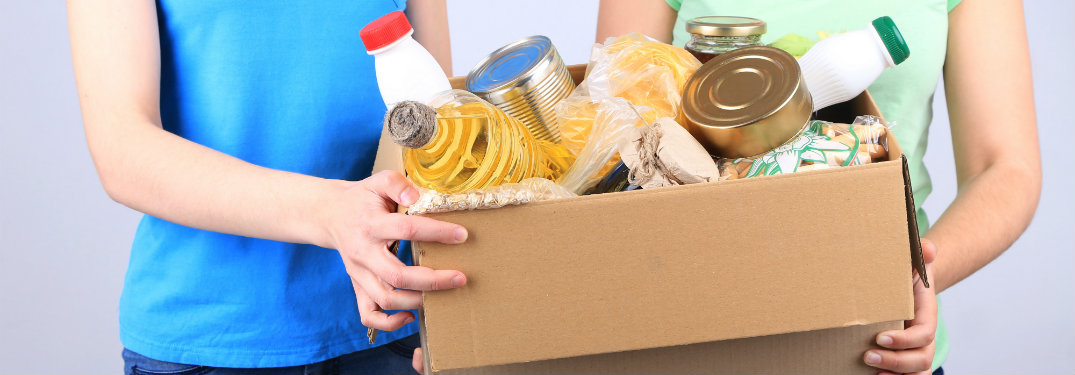 people holding a box of food
