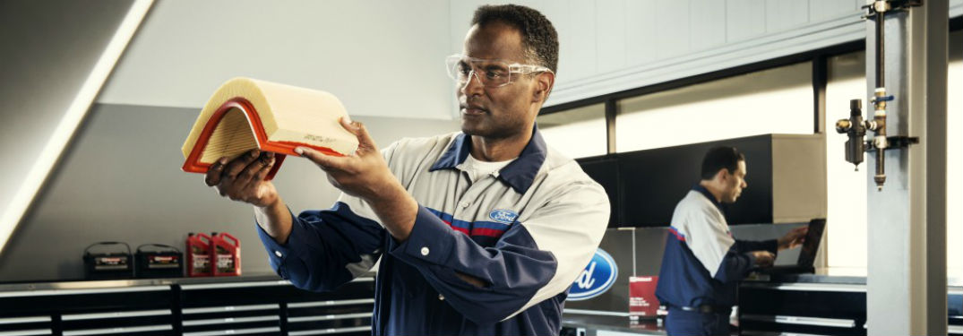 Ford service techs inspecting a filter