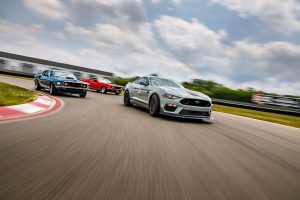 three Ford Mustang race cars