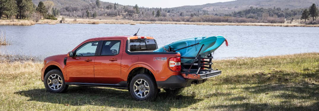 side view of a red 2022 Ford Maverick hauling a kayak