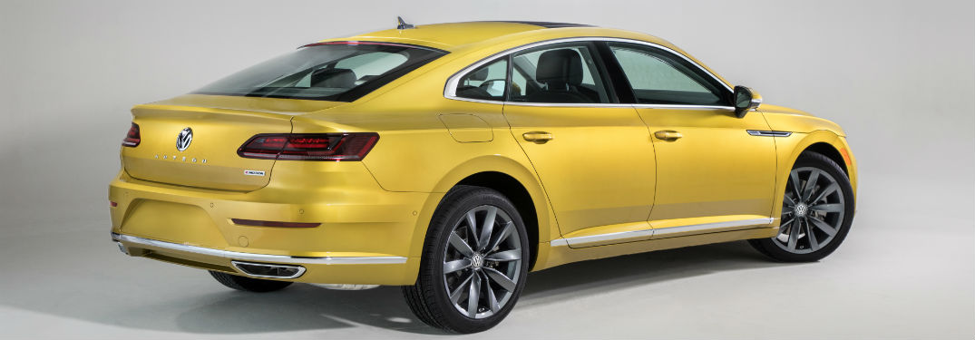 Passenger rear quarter panel exterior view of a yellow 2019 VW Arteon