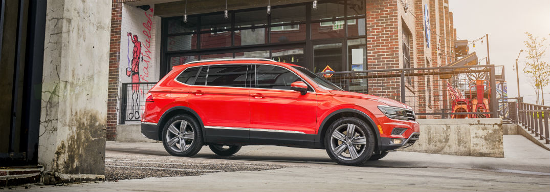 Passenger side exterior view of an orange 2018 VW Tiguan