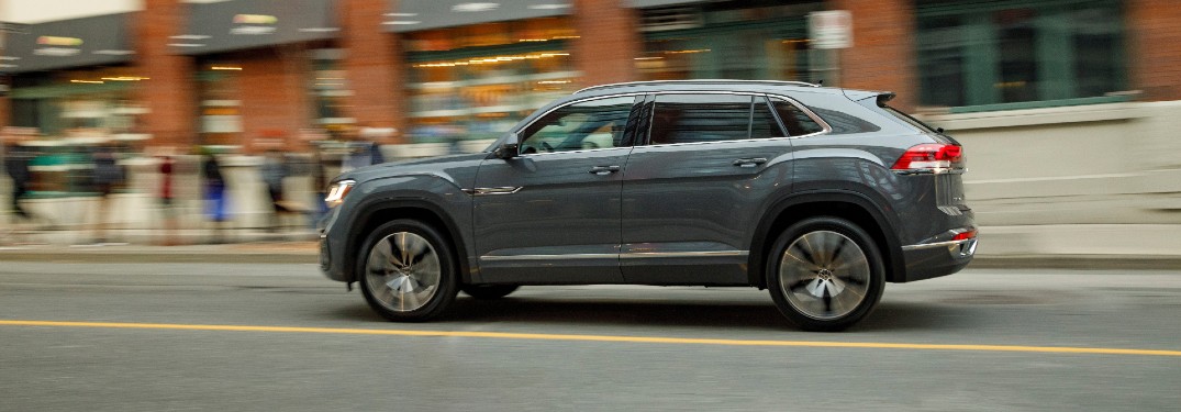 2020 Volkswagen Atlas Cross Sport SEL Premium R-Line model with Pure Gray paint color exterior side shot driving through a city