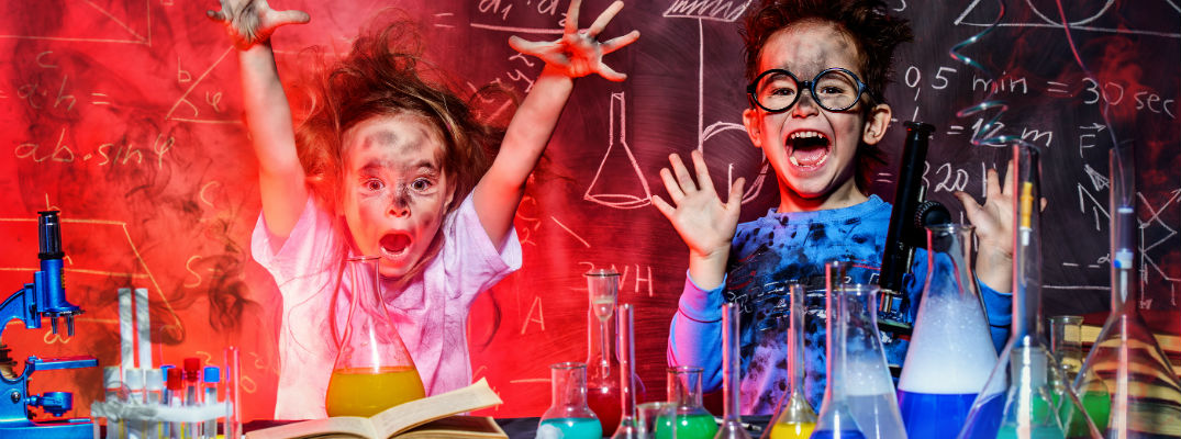 A stock photo of two young girls making a mess with a science experiment.