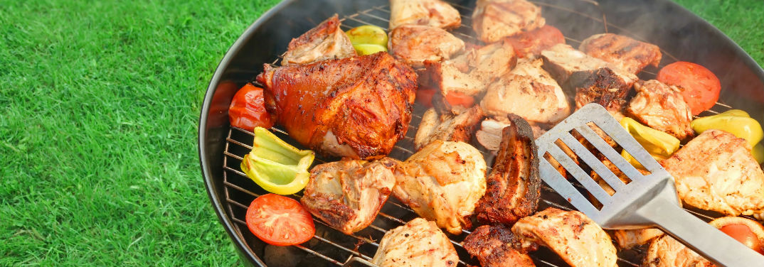 Tips for the Perfect Summer Cookout with image of grill filled with meat
