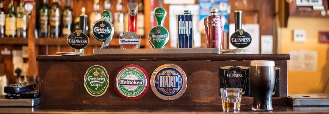 Beer Taps at Irish Pub with Guinness and Harp