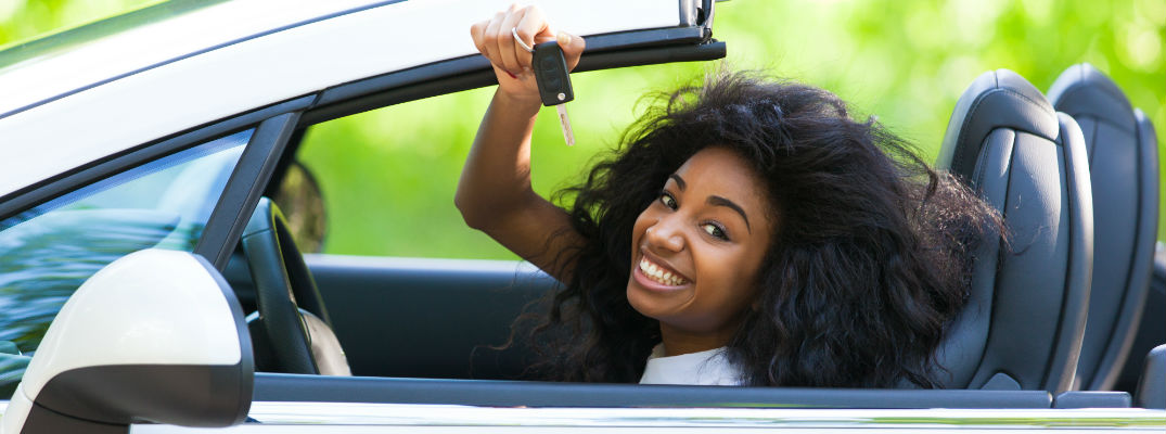 A woman with keys to a new car