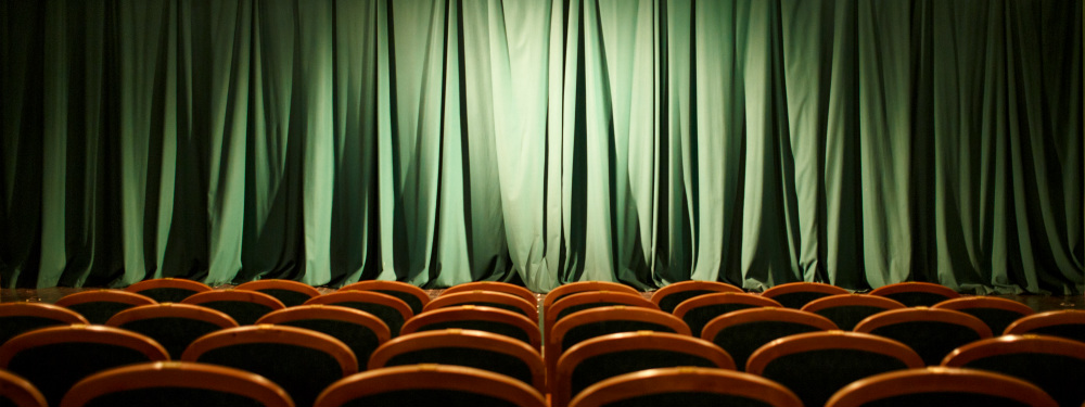 Empty theatre seats with curtains drawn