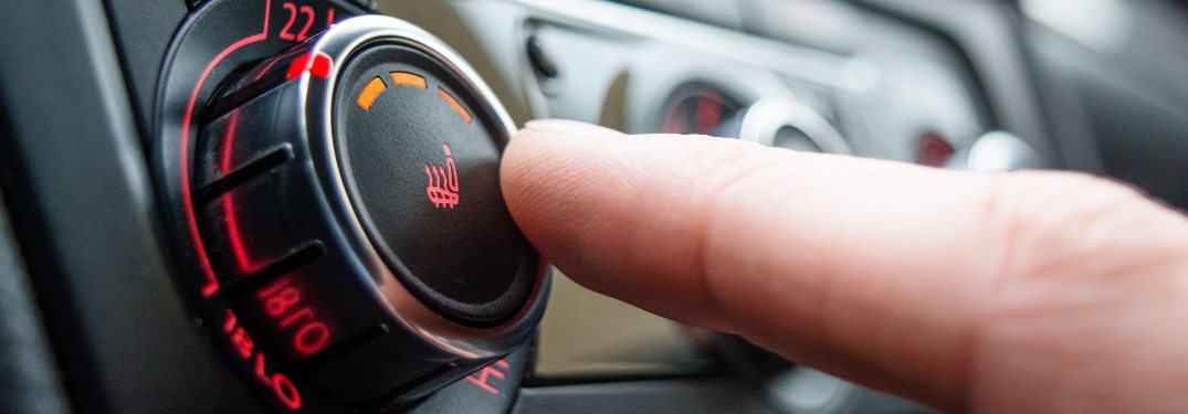 Person pressing heated seats button