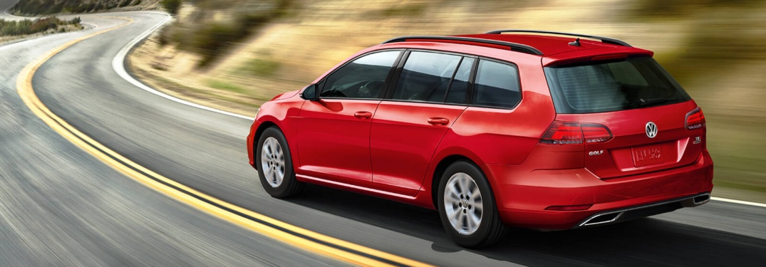 Red 2018 VW Golf SportWagen rounding a corner
