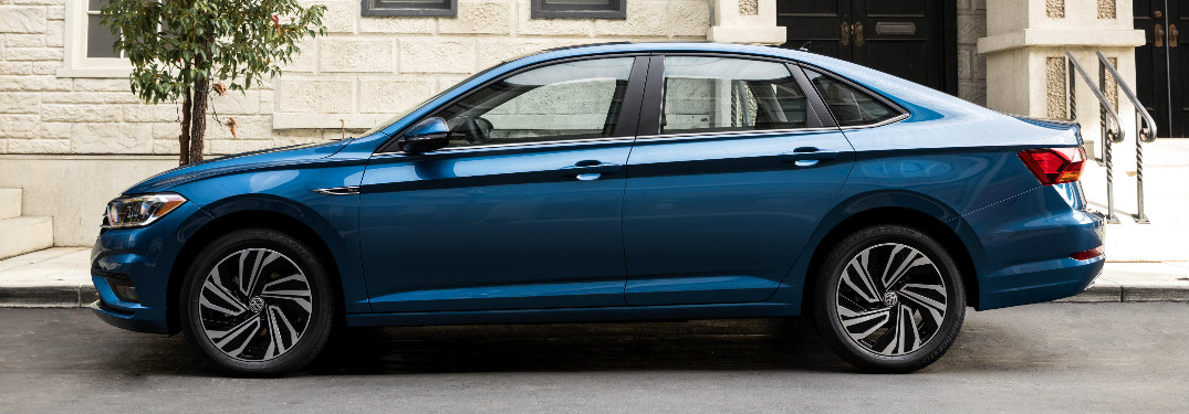 2019 Volkswagen Jetta in blue parked in front of a stone building
