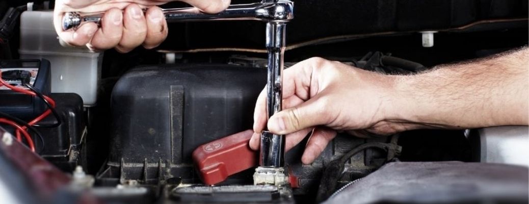 Mechanic's hands working on a vehicle's engine