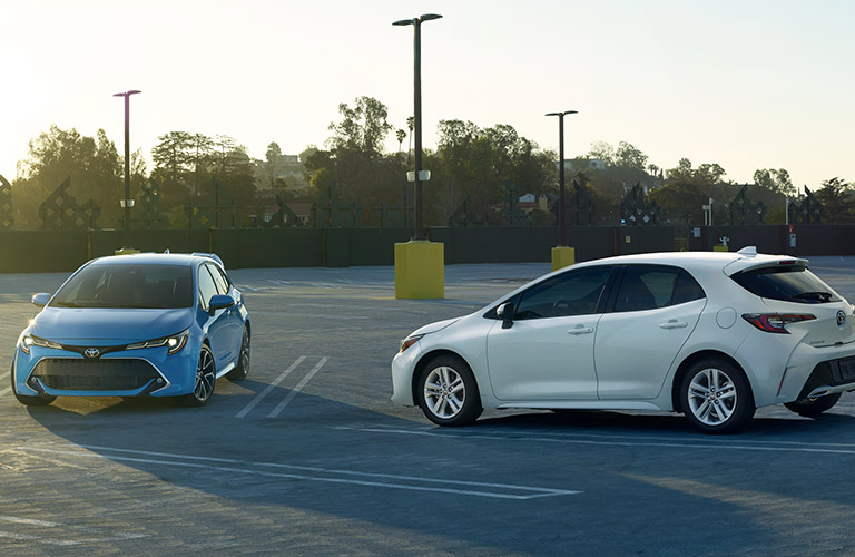 two 2019 Toyota Corolla Hatchback models parked in a parking lot