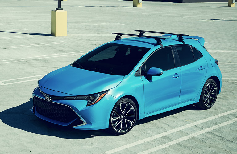 Blue 2019 Toyota Corolla Hatchback parked with roof rails