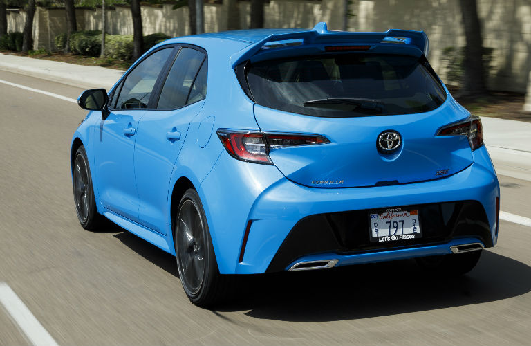 rear view of blue 2019 Toyota Corolla Hatchback driving