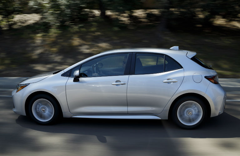 side profile view of silver 2019 Toyota Corolla Hatchback model driving