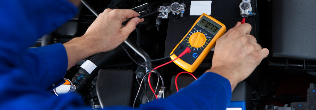 Man checking car battery levels