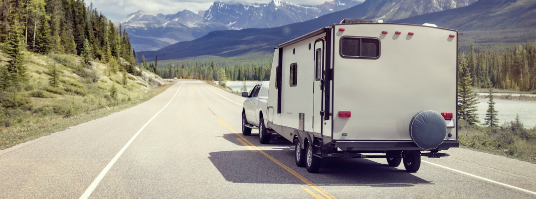 Trailer being towed with mountains in the background