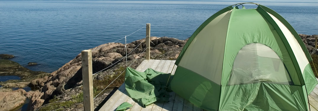 tent on a cliff overlooking water