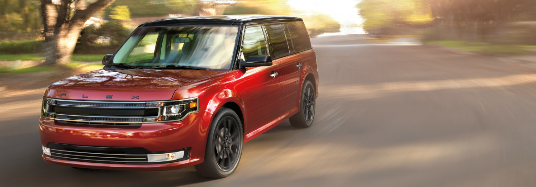 red 2018 ford flex driving down suburban road
