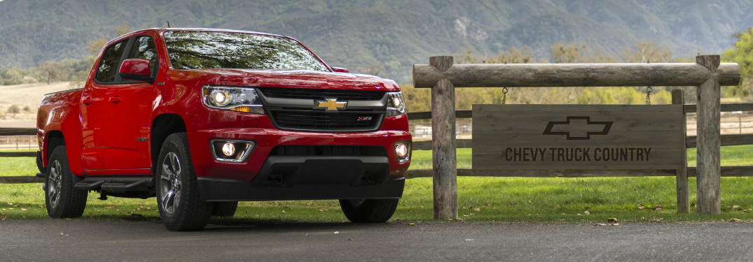 red 2018 chevy colorado on ranch road next to wooden sign that says "chevy country"